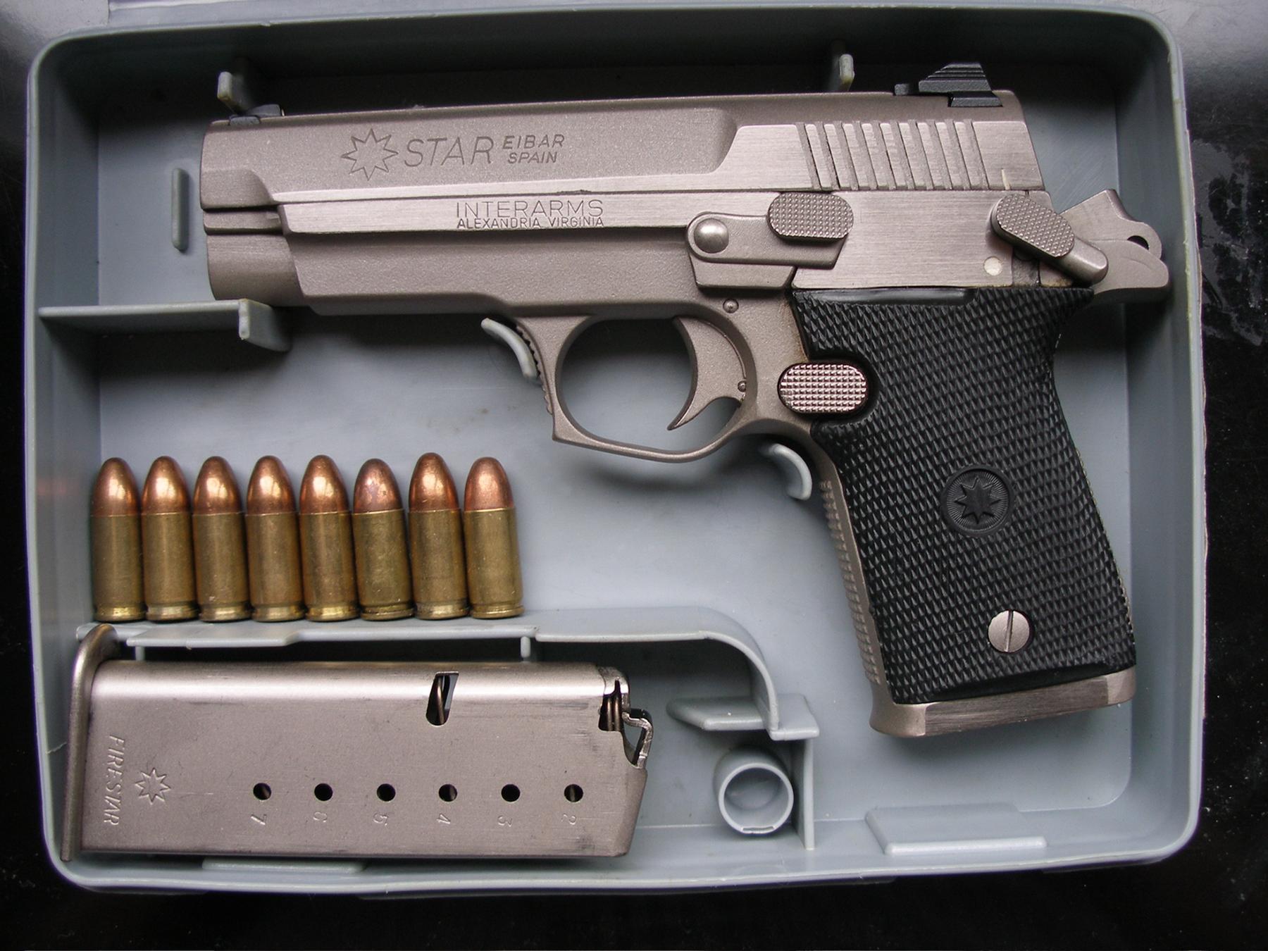a silver and black gun and a bunch of bullets - File:Star M43 Firestar.jpg